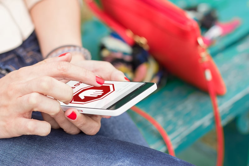 Woman on mobile phone, showing an egregious ad.