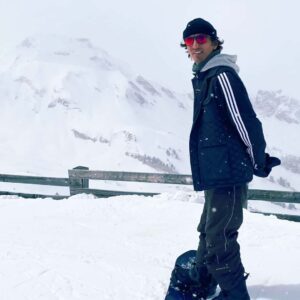 Arun Roy standing on a snowboard in Haute-Savoie in the French Alps