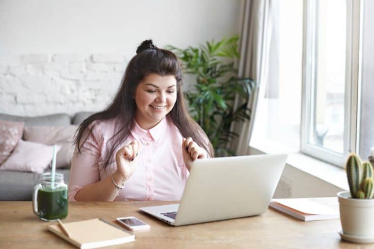 Woman working on a laptop computer.