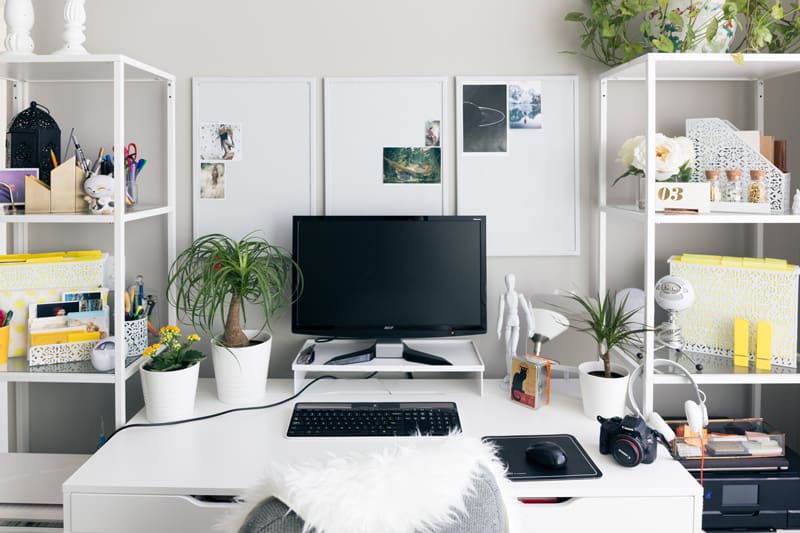 A larger work station on a white desk, with ample storage for files on either side in towers.