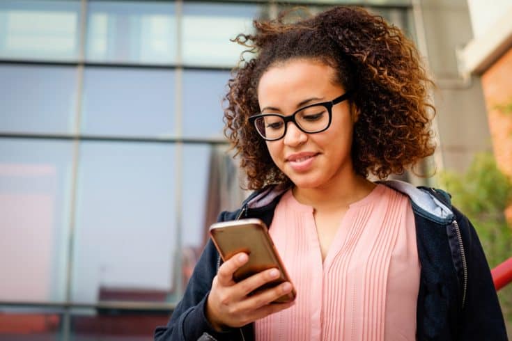 A woman uses a smart phone.