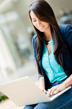 A blogger typing on a laptop.