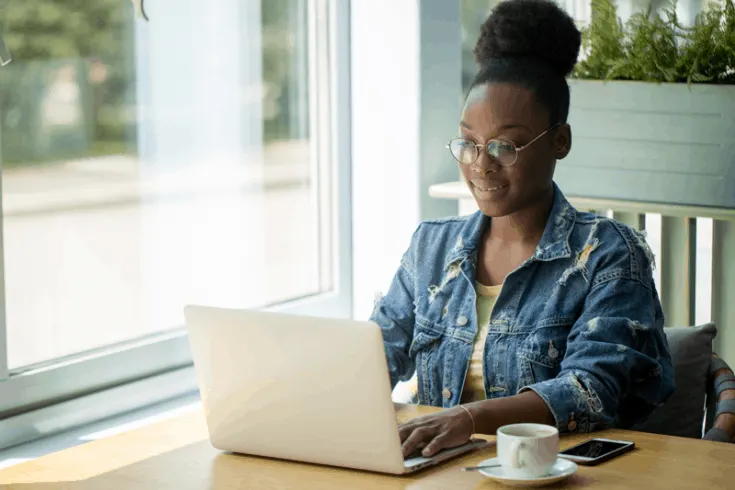 A woman typing on a laptop computer.