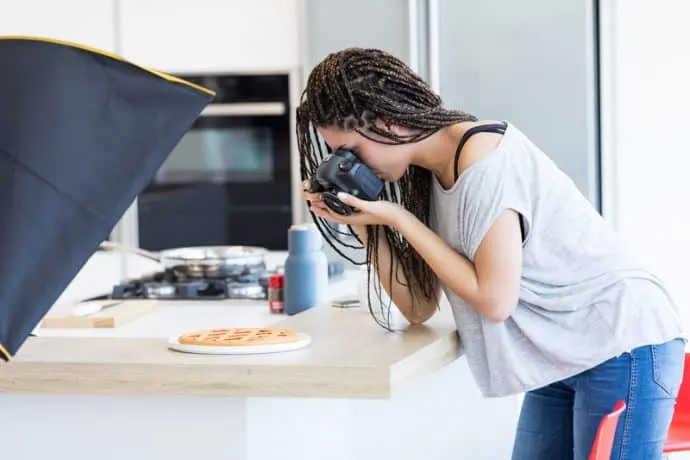 woman taking photos of food